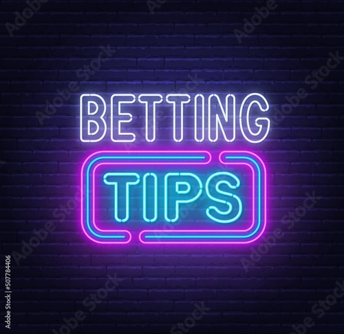 Fototapete Betting tips neon sign on a brick background.