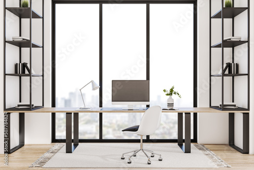 Modern office interior with book shelves, furniture, panoramic city view and empty white mock up computer screen. Creative designer desktop concept. 3D Rendering.