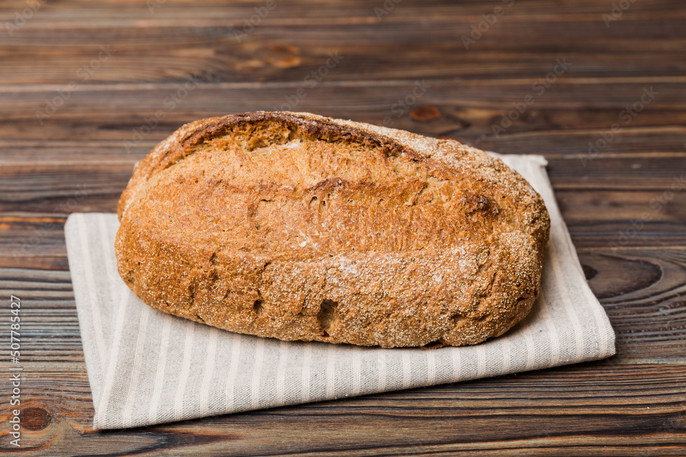 freshly baked bread with napkin on rustic table top view. Healthy white bread loaf isolated freshly baked bread with napkin on rustic table top view. Healthy white bread loaf isolated