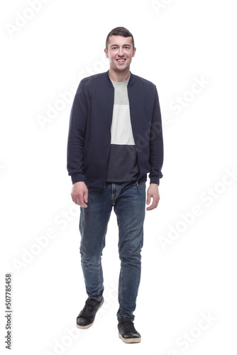 young man in jeans striding forward . isolated on a white