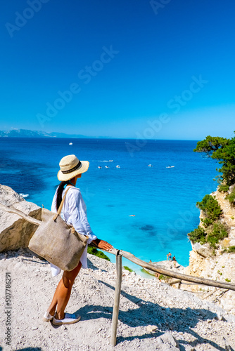 Golfo di Orosei Sardina, Asian women on the beach Sardinia Italy, a young girl on vacation Sardinia Italy, woman playing in the ocean with crystal clear blue water, photo