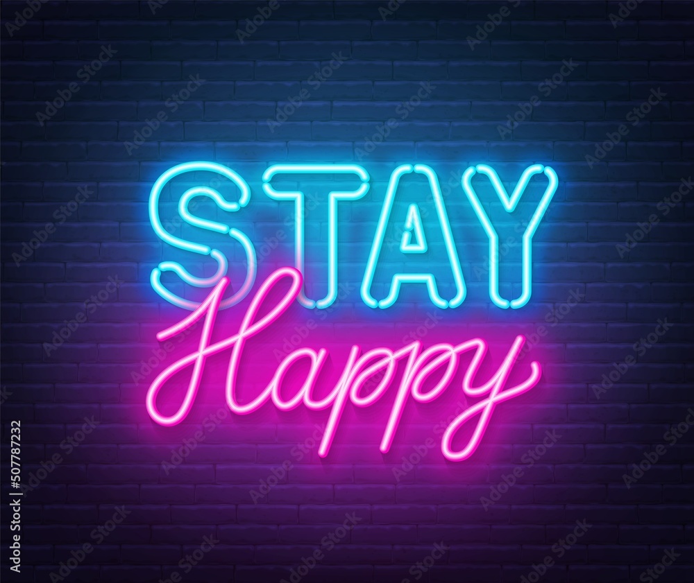 Stay Happy neon quote on a brick wall.