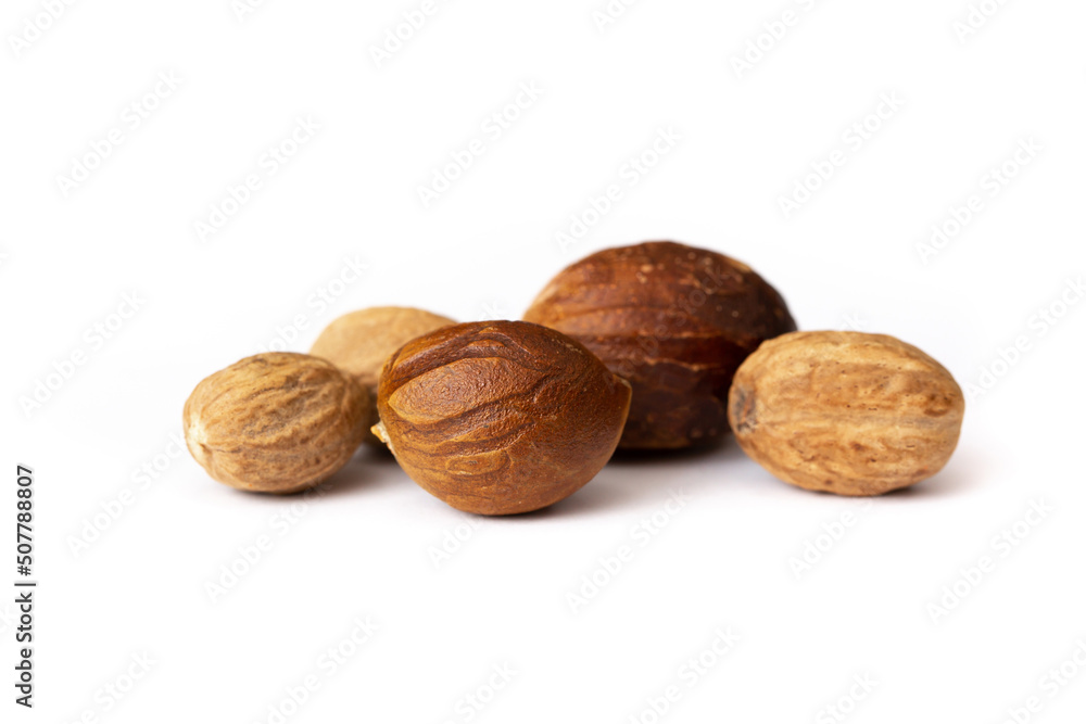Nutmeg close-up on a white background. Indian spices close up. Medicinal herbs and spices. Nutmeg close-up on a white background. Indian spices close up. Medicinal herbs and spices.