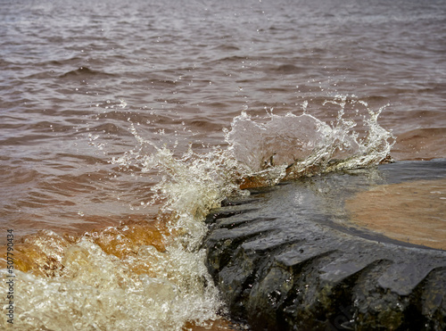 view of the sandy beach by the Baltic Sea. Seashore with old car tires and concrete, human waste, Curonian Spit, Russia