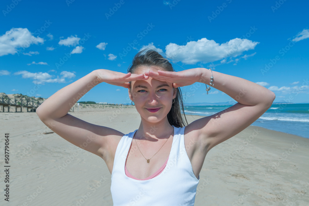 close-up of blue-eyed blonde girl on beach