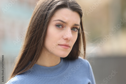 Angry and suspicious woman looking at camera photo