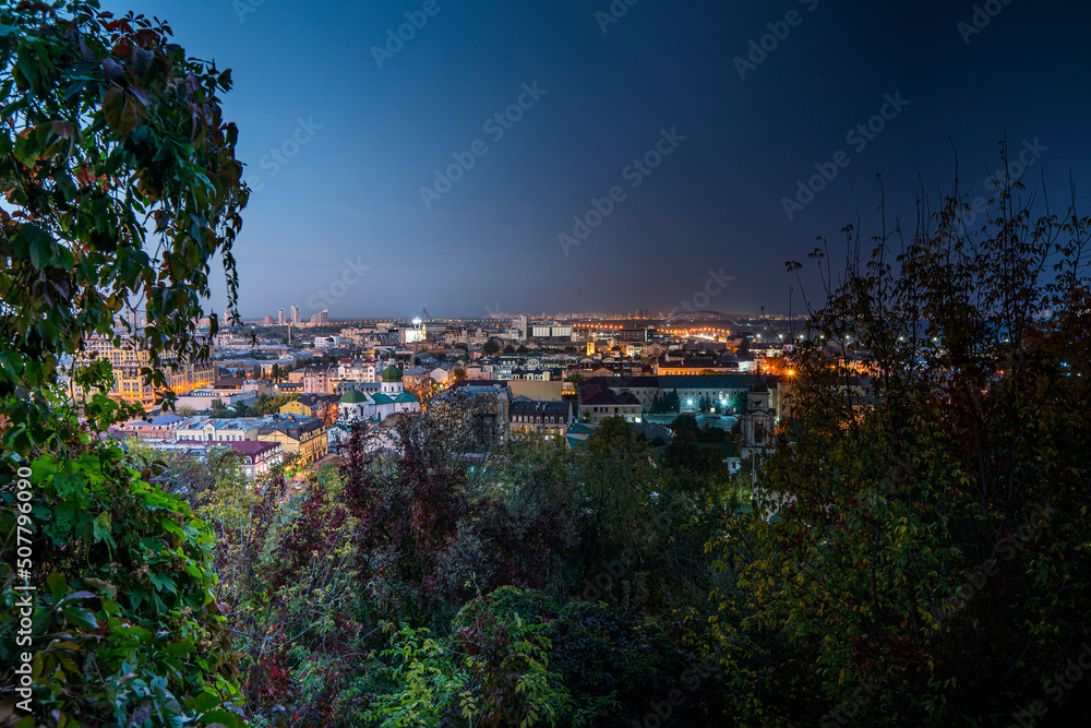 Kyiv, Ukraine - October 02, 2019 - Night day gradient of urban cityscape. Podil panorama view from castle mountain, Zamkova gora
