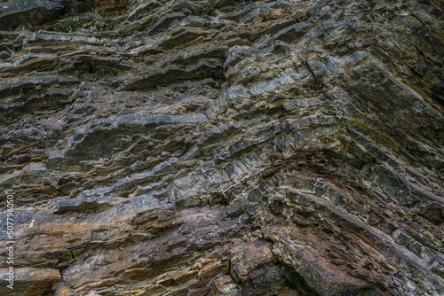Granite rock wall texture. Mountain stone geological layers
