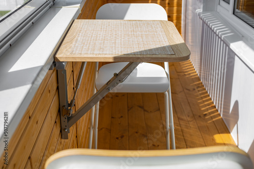 folding wall table in the unfolded position on the balcony photo