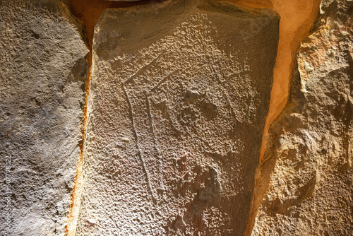Artistic manifestation engraved in the stone in the megalithic monument of El dolmen de Soto photo