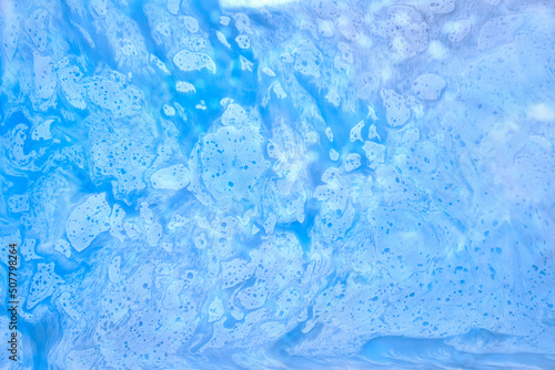 Blue ink abstract background  winter paint pattern under water  acrylic pigment stains  splashes and streaks