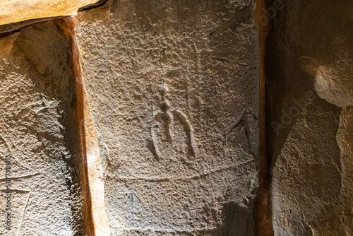 Artistic manifestation engraved in the stone in the megalithic monument of El dolmen de Soto photo
