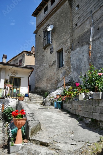 A narrow street between the old houses of Marsicovetere, a village in the mountains of Basilicata, Italy. photo