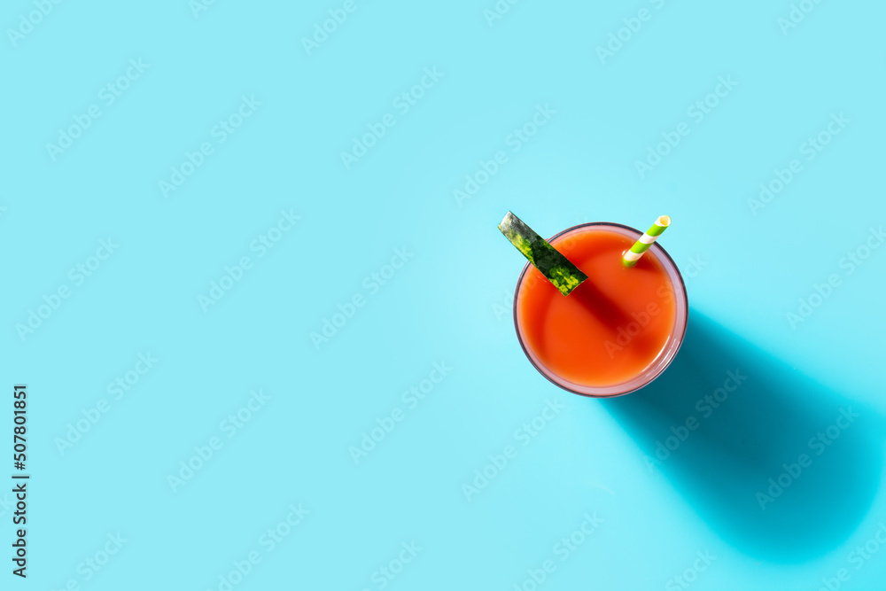 Fresh watermelon juice on blue background. Top view. Copy space Fresh watermelon juice on blue background. Top view. Copy space