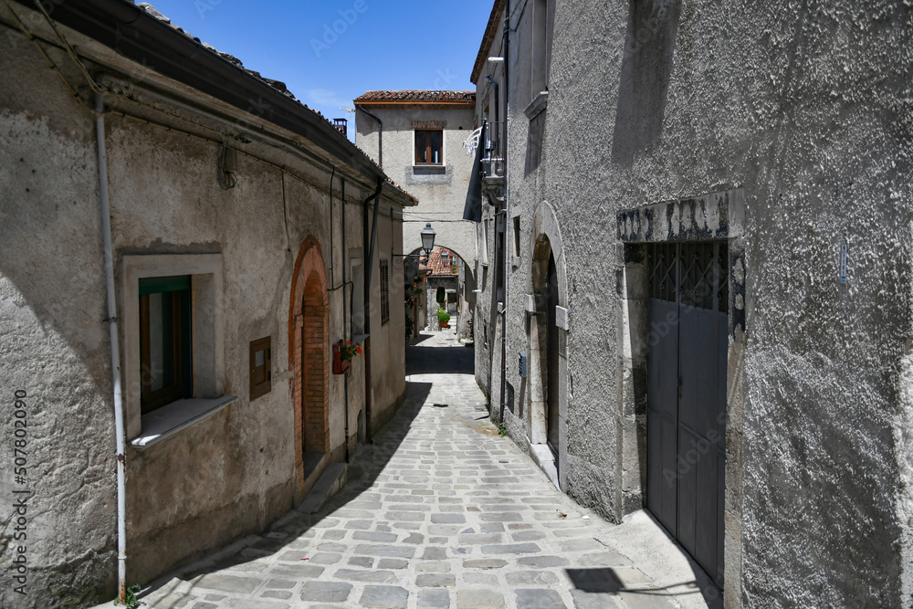 A narrow street between the old houses of Marsicovetere, a village in the mountains of Basilicata, Italy.