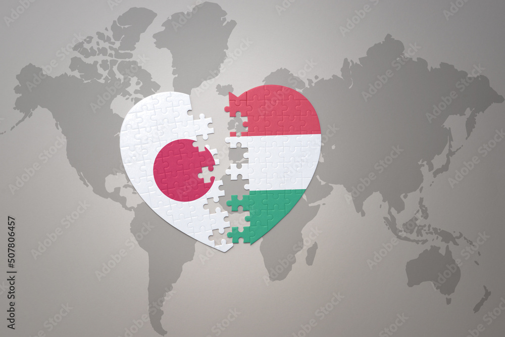 puzzle heart with the national flag of japan and hungary on a world map background. Concept. 3D illustration puzzle heart with the national flag of japan and hungary on a world map background. Concept. 3D illustration