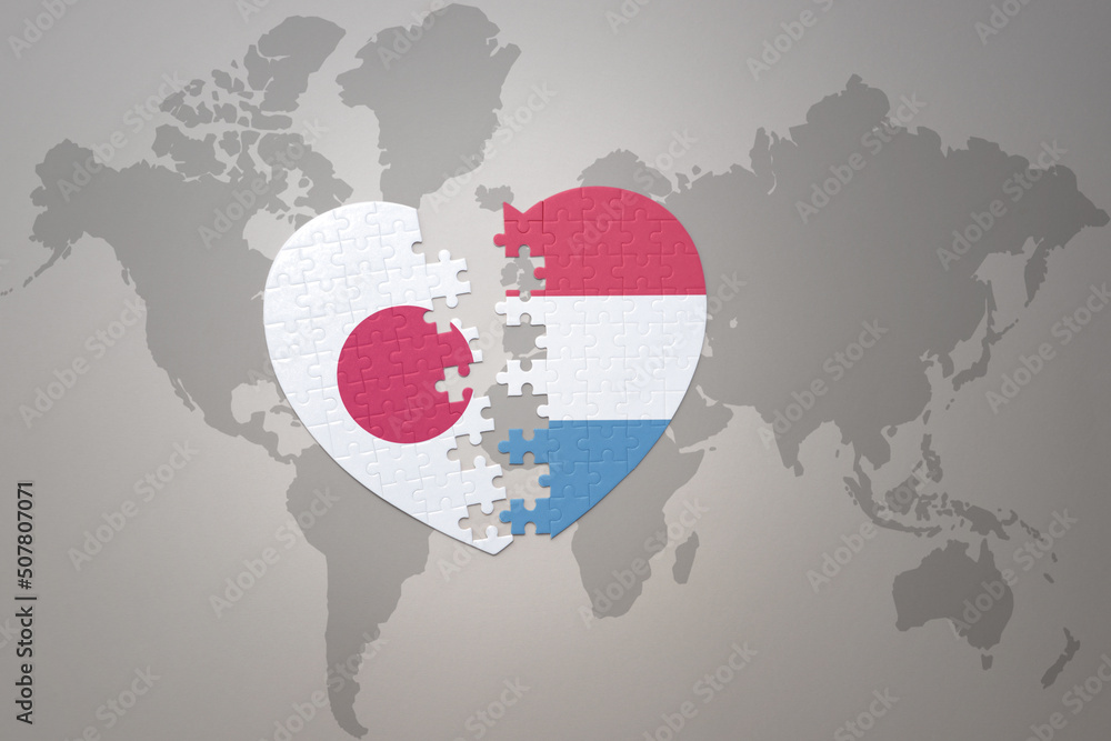 puzzle heart with the national flag of japan and luxembourg on a world map background. Concept. 3D illustration puzzle heart with the national flag of japan and luxembourg on a world map background. Concept. 3D illustration
