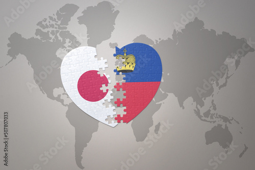 puzzle heart with the national flag of japan and liechtenstein on a world map background. Concept. 3D illustration