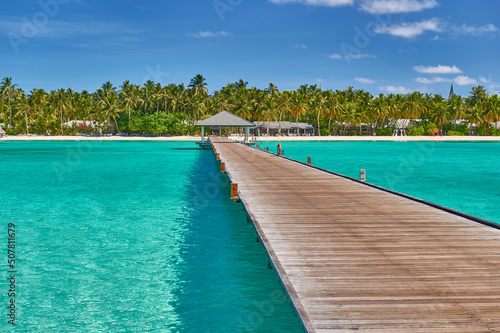 Maldives paradise scenery. Tropical aerial landscape, seascape with long jetty, water villas with amazing sea and lagoon beach, tropical nature. Exotic tourism destination banner, summer vacation © Alvov
