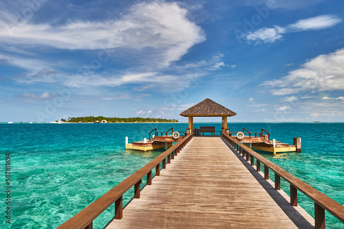 Maldives paradise scenery. Tropical aerial landscape, seascape with long jetty, water villas with amazing sea and lagoon beach, tropical nature. Exotic tourism destination banner, summer vacation © Alvov