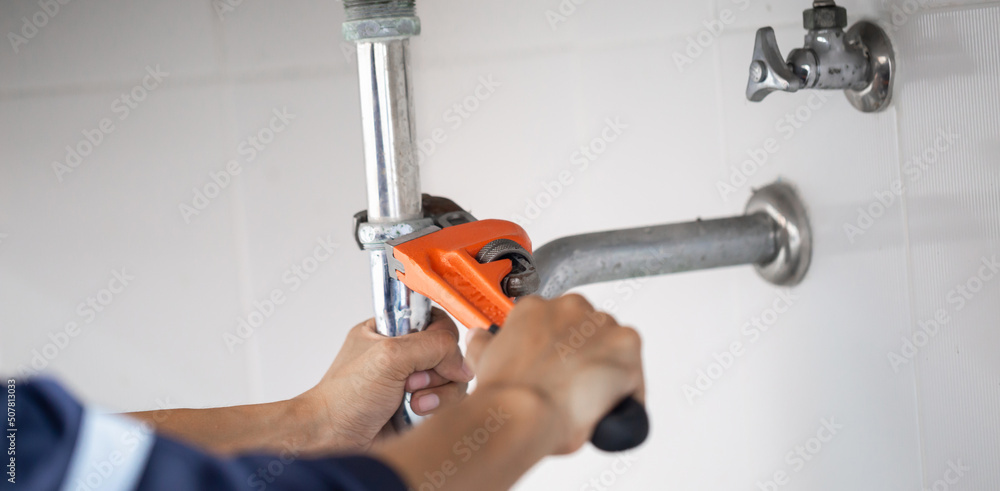 plumber at work in a bathroom, plumbing repair service, assemble and install concept. plumber at work in a bathroom, plumbing repair service, assemble and install concept.