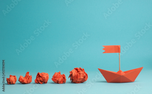 New ideas or transformation concept with crumpled paper balls and a boat, transformation or teamwork concept, creativity, make a change