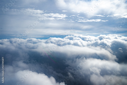 Clouds and aerial view as seen in window of an aircraft