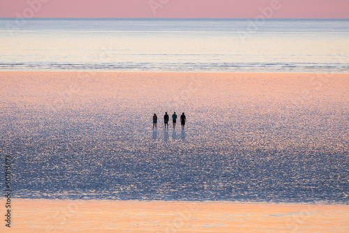 Friends are enjoying the beautiful view at 80 mile beach, in Broome, Western Australia (close up) photo