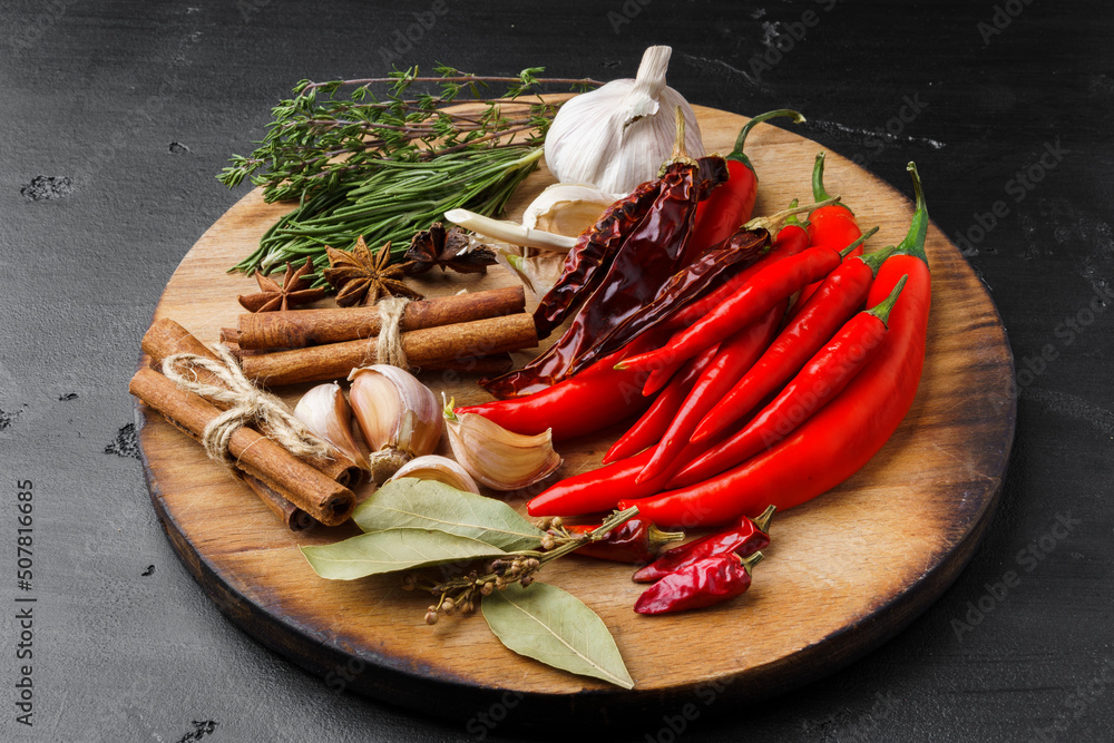 Garlic cloves and spices on black background Garlic cloves and spices on black background