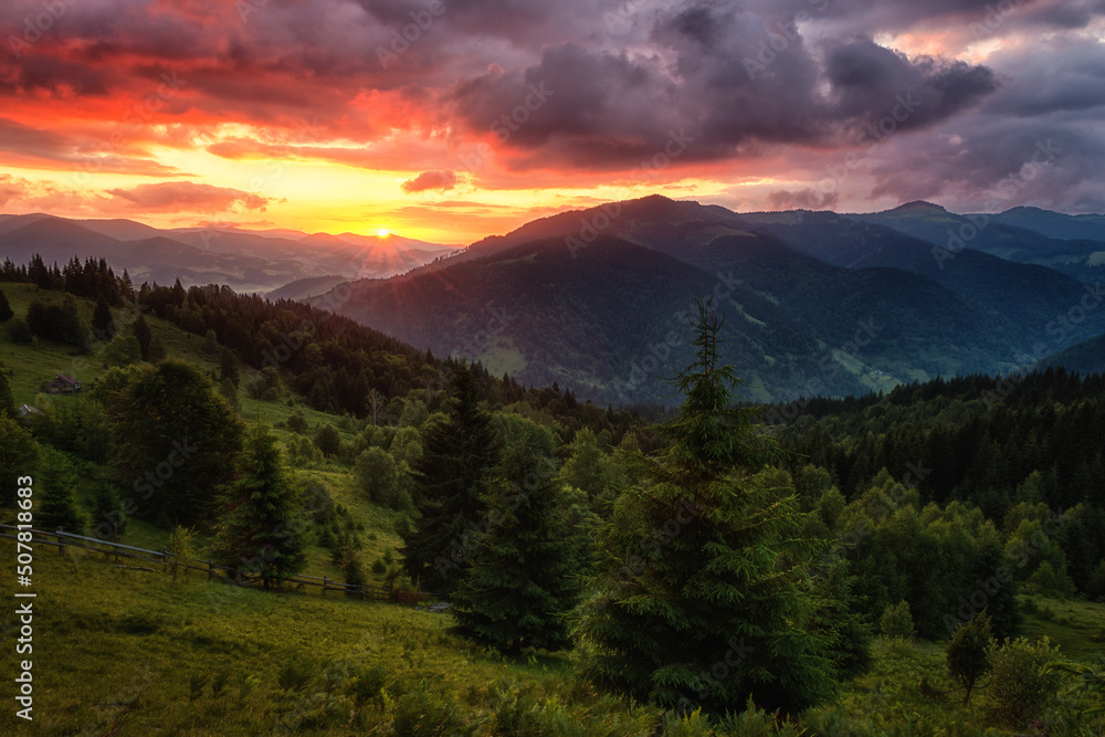 Amazing sunset mountain landscape. Fantastic view of the green summer hill and colored sky with clouds, natural outdoor travel background, Carpathian Biosphere Reserve