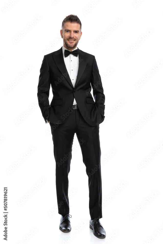 businessman holding hands in pocket and posing with a smile businessman holding hands in pocket and posing with a smile