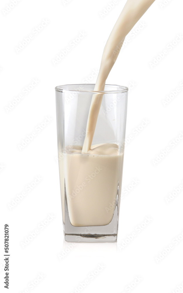 Milk pouring into the clear glass isolated on white background Milk pouring into the clear glass isolated on white background