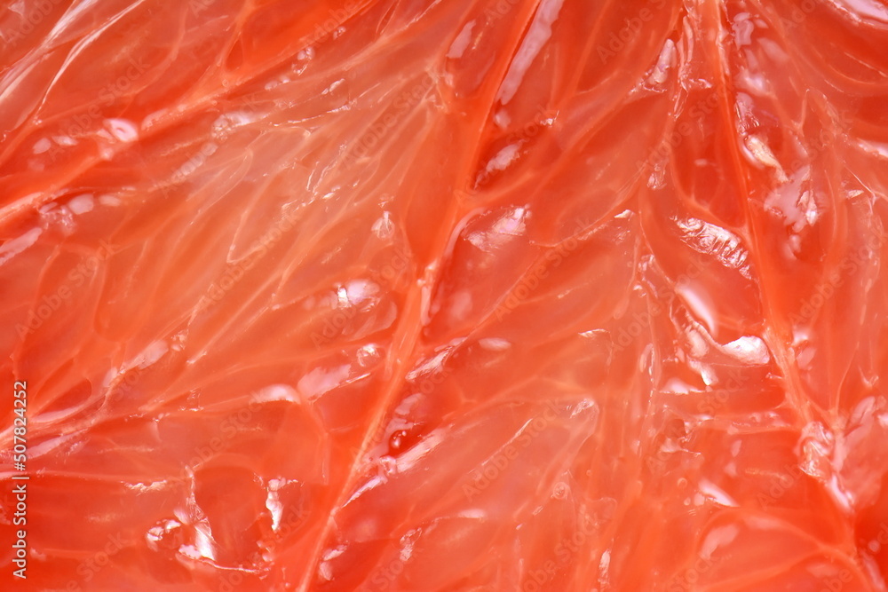 Top view of grapefruit slice, as background. Macro of red grapefruit. fruit citrus grapefruit texture background Top view of grapefruit slice, as background. Macro of red grapefruit. fruit citrus grapefruit texture background