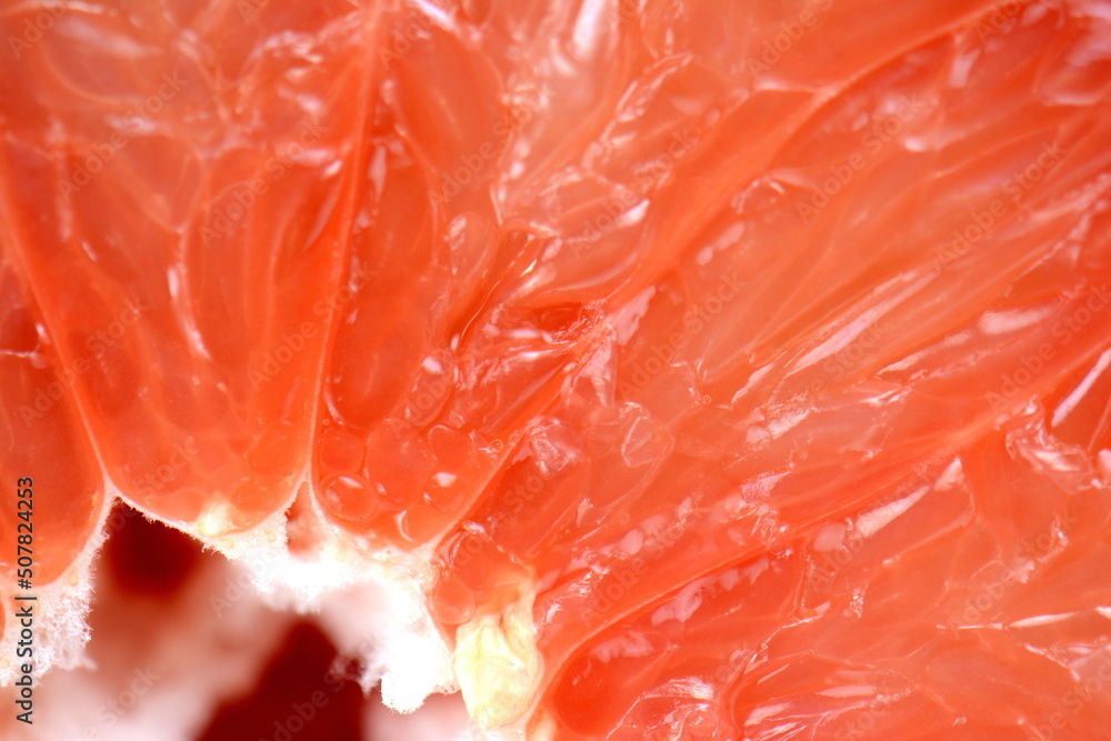 Top view of grapefruit slice, as background. Macro of red grapefruit. fruit citrus grapefruit texture background Top view of grapefruit slice, as background. Macro of red grapefruit. fruit citrus grapefruit texture background