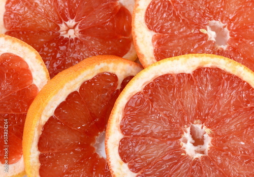 Top view of grapefruit slice, as background. Macro of red grapefruit. fruit citrus grapefruit texture background