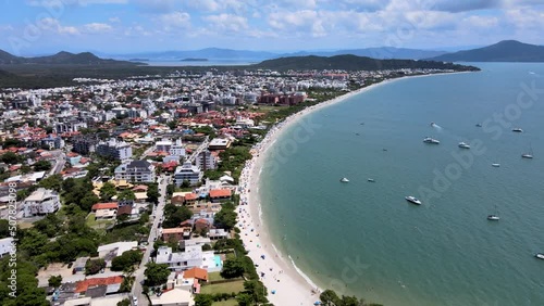 Aerial drone view of urbanized tropical luxury beach with oceanfront summer houses in florianópolis jurere internacional photo