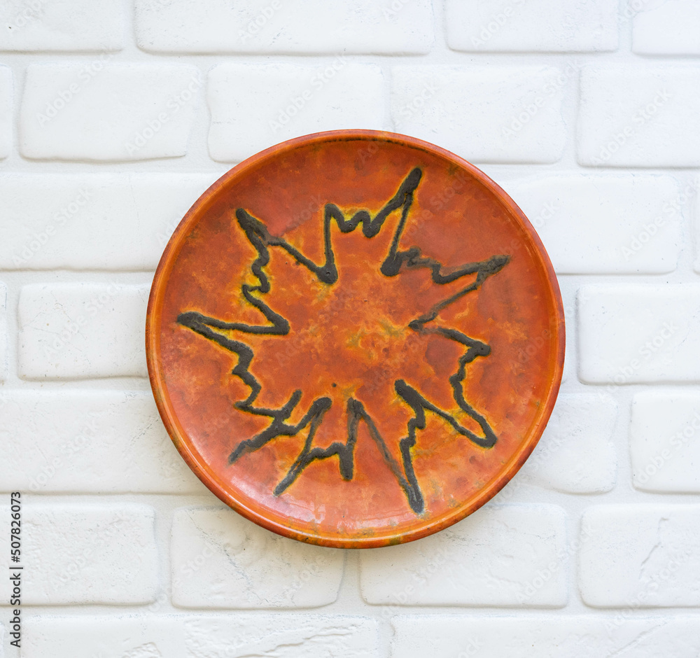 Mid-century modern pottery - orange wall plate
