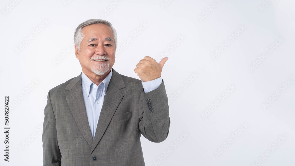 Asian senior businessman , old man with suit feel happy good health pointing finger to empty copy space for present product or blank space for advertising isolated on white background Asian senior businessman , old man with suit feel happy good health pointing finger to empty copy space for present product or blank space for advertising isolated on white background