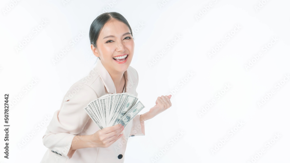 Successful beautiful Asian business young woman fill happy holding money US dollar bills in hand isolated on white background , business success concept Successful beautiful Asian business young woman fill happy holding money US dollar bills in hand isolated on white background , business success concept