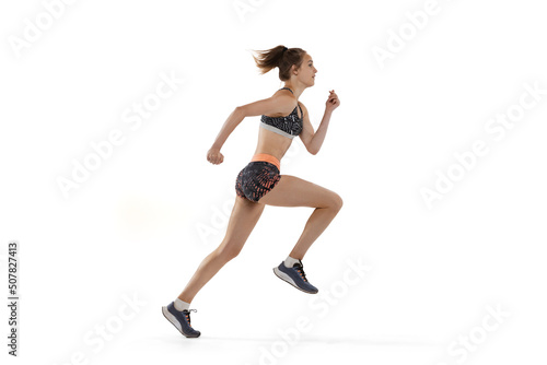 Development of movements in long jump sport. One professional female athlete in sports uniform jumping isolated on white background.