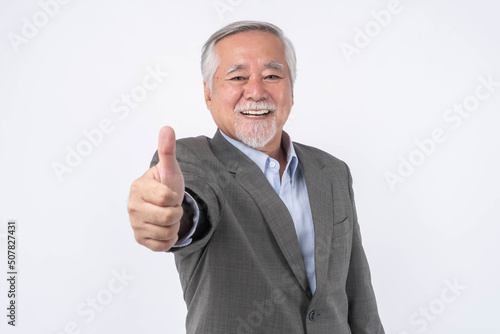  Asian senior businessman , old man with suit giving a thumb up hand on white background with copy space - lifestyle senior male concept