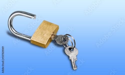 Simple lock and key. Small worn padlock with shiny key. Business data encryption, home security, or other safeguarding metaphor.