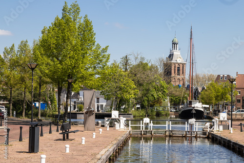 Small harbor in the center of the city of Meppel with a view of the church tower.