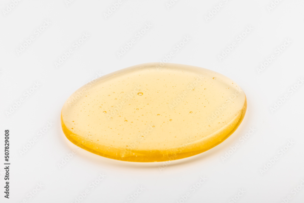 Honey flows. Drops of yellow syrup flow. Natural product and sweet drink. Isolated on white background. Honey flows. Drops of yellow syrup flow. Natural product and sweet drink. Isolated on white background.