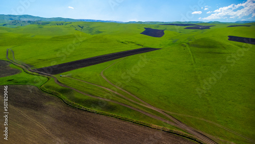 Top view from a drone on mountain pastures and road © Марем Гукежев