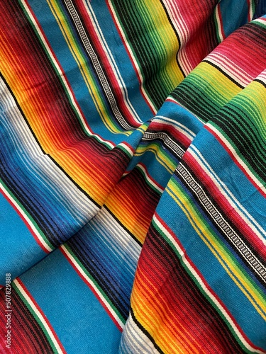 poncho serape Mexican background for Mexico cinco de mayo fiesta wooden copy space stripe pattern minimalist simple Mexican background backdrop - stock photo,
