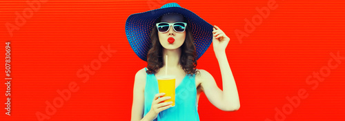 Photography Portrait of beautiful young woman drinking fresh juice from cup wearing summer h