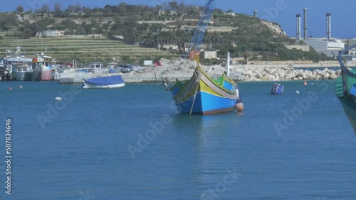 Colourful Traditional Maltese Fishing Boat, The Luzzu at Marsaxlokk Harbour. Handheld Shot photo