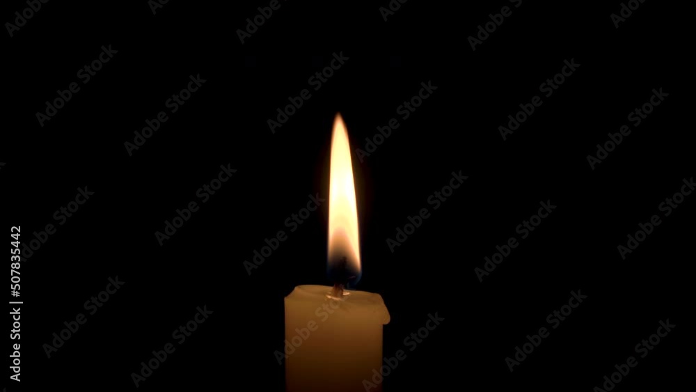A Candle Burns with a Bright Flame on a Black Background. The Flame of a Wax Candle Glows Mysteriously in the Darkness. 4k illustration of Remembrance, Celebration or Religious Ceremony A Candle Burns with a Bright Flame on a Black Background. The Flame of a Wax Candle Glows Mysteriously in the Darkness. 4k illustration of Remembrance, Celebration or Religious Ceremony