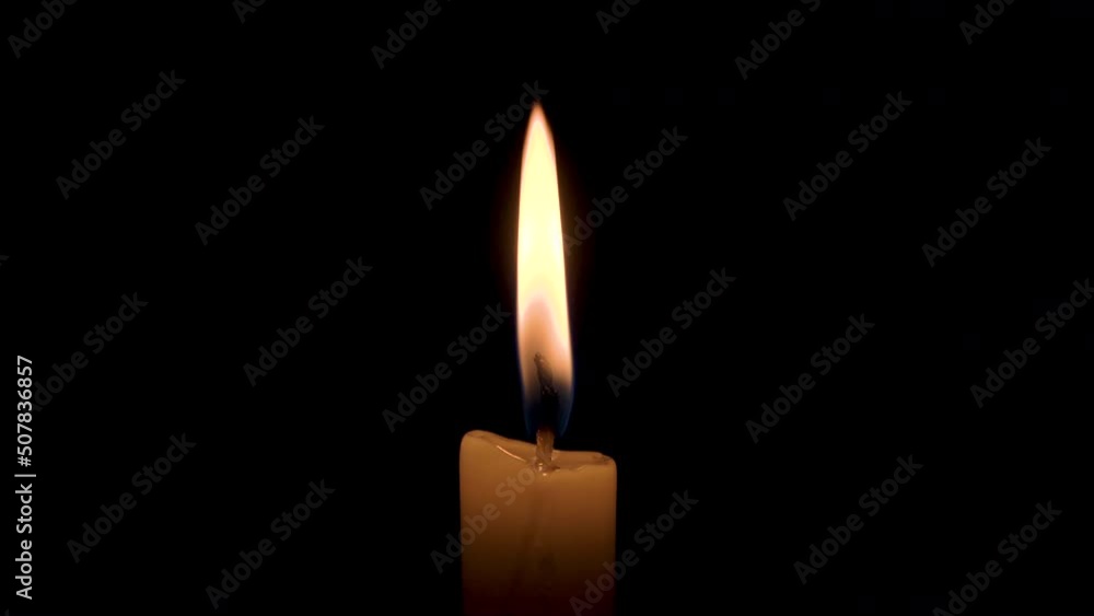 A Male Hand Lights a Wax Candle with a Match on a Black Background. Bright Flame, Glowing Fire, Ignition in the Darkness. 4k Concept of Memory, Ritual, Remembrance, Celebration or Religious Ceremony A Male Hand Lights a Wax Candle with a Match on a Black Background. Bright Flame, Glowing Fire, Ignition in the Darkness. 4k Concept of Memory, Ritual, Remembrance, Celebration or Religious Ceremony